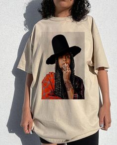 Vintage Erykah Badu tee, Erykah Badu fans Shirt , Erykah Badu Graphic , Erykah fans, Erykah  tour Gift for men women unisex tshirt  Heather colors are 52% combed and ring-spun cotton, 48% polyester - Athletic and Black Heather are 90% combed and ring-spun cotton, 10% polyester - Solid Colors 100% pre-shrunk cotton - Fiber content may vary by color FOR THE BEST FIT; (See Size Chart in Images). 1) Lay a t-shirt on a flat surface. 2) Measure the chest area, just under the armpit from side to side f Oversized Short Sleeve Fan Merchandise T-shirt, Unisex T-shirt For Fall Streetwear, Oversized Graphic Print Fan Merchandise T-shirt, Oversized Graphic Print T-shirt For Fan Merchandise, Spring Streetwear T-shirt With Custom Print, Fan Merchandise Graphic Print T-shirt, Sublimation Print T-shirt For Fall Streetwear, Hip Hop Style Summer Fan Merchandise Tops, Oversized Cotton T-shirt In Pop Culture Style