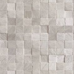 a white tile wall that is made up of small squares