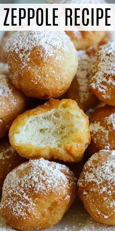 a pile of powdered sugar covered doughnuts on top of a white plate