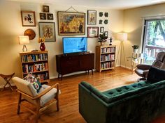 a living room filled with furniture and a flat screen tv sitting on top of a wooden floor