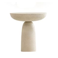 a white table with a pedestal on the top and one leg in the shape of a birdbath