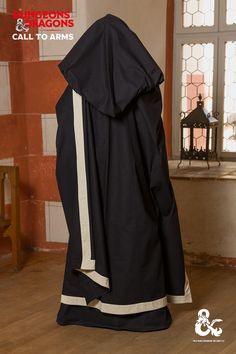 Adorn yourself in a shroud of mystery with our D&D Wizard Cape, a must-have for any fan of the popular role-playing game. Not only does this cape provide a sense of drama, but it's also highly functional. The cape features integrated loops at the neckline for closure or a brooch, inside straps to fix the cape at back or above the chest, and contrast color facing around the edge. A large draping hood provides an air of mystery or danger to any spellcaster who wears it. Color: Black/Natural Note: Shown accessories are not included. They are for display purposes only. The colors shown may differ from the actual colors depending on the resolution of your screen. Medieval Black Cape For Costume Party, Black Elvish Cape For Larp, Black Elvish Costume For Fantasy Events, Black Elven Costumes For Larp, Black Medieval Cape For Cosplay, Black Medieval Costume For Fantasy Events, Medieval Black Costume For Fantasy Events, Wizard Cape, Black Week