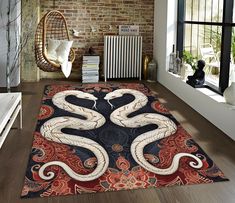 a large rug with two snakes on it in a room next to a brick wall