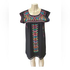 The Beautiful Tehuacn Dress Just Got Even Cuter With Lace Accents! Made In Cotton Manta Fabric With Silk Thread Embroidery. Available In Size Small, Medium, Large And X-Large. Please Consider That The Colors And Patterns Of The Embroidery Are Always Different Than The Ones In The Pictures. Traditional Black Spring Dresses, Traditional Black Summer Dress, Black Bohemian Embroidered Mini Dress, Bohemian Black Knee-length Mini Dress, Black Bohemian Knee-length Mini Dress, Black Floral Embroidered Beach Dress, Beach Black Embroidered Dress With Floral Details, Black Embroidered Bohemian Dress, Black Embroidered Mini Dress For Summer