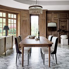 a dining room table with chairs and a chandelier