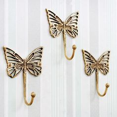 three butterfly hooks hang on the wall