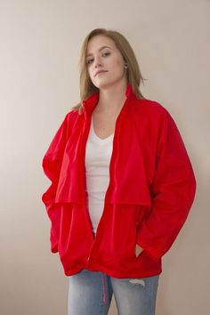 This is a retro Eddie Bauer Wind breaker 100% Nylon. Bright red in colour with mess lining inside covering the venting. There is a hood that can be tucked and zipped away if you prefer not to use it. The bottom has pull ties to make it more fitted. Front Pockets are zip.Measurements:Shoulder to Hem  27"Bottom Circumference(at Hip) 44"Sleeve length 28"Size listed Women's MModel is a size 8Great vintage condition Retro Red Hooded Windbreaker, Red Retro Hooded Windbreaker, Red Retro Track Jacket For Outdoor, Retro Red Track Jacket For Outdoor, Retro Red Windbreaker For Fall, Red Retro Windbreaker With Pockets, Retro Red Windbreaker With Pockets, Red Long Sleeve Nylon Windbreaker, Red Nylon Outerwear With Pockets