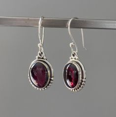 Sterling silver oval Garnet earrings Matching necklace  available. Gift box available for purchase. Search GIFTBOX Oval Garnet Gemstone Earrings, Oval Pendant Gemstone Earrings For Gift, Gemstone Earrings With Oval Pendant For Gifts, Silver Garnet Birthstone Earrings, Sterling Silver Oval Cabochon Earrings Gift, Garnet Earrings Silver, Red Garnet Earrings, Earrings Matching, January Birthstone Jewelry