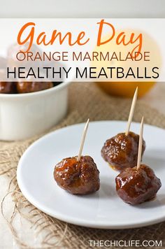 orange marmalade meatballs with toothpicks in them on a white plate