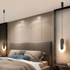 a bedroom with a bed, nightstands and two lamps hanging from the ceiling above it