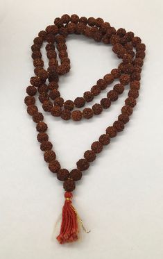 "Beautiful vintage genuine quandong seed bead necklace or prayer bead necklace good pre/owned measures 19\" across and 38\" overall length." Handmade Brown Necklace For Puja, Spiritual Brown Polished Beaded Necklaces, Spiritual Rosary With Large Beads, Traditional Brown Beaded Necklace Hand-strung, Brown Beaded Necklaces For Meditation And Festivals, Spiritual Beaded Necklace With Large Beads For Festivals, Traditional Brown Hand-strung Beaded Necklaces, Spiritual Beaded Necklaces For Festivals, Brown Necklaces For Puja And Festivals