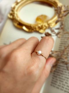 ✨ Tiny Freshwater Pearl Ring with choices of 14K Gold Filled, Rose Gold Filled or 925 Sterling Silver, June Birthstone Gift 💙 Dainty stacking ring with one small pearl. Make a very cute pinky ring. *Pearl Size: 4 mm *Ring Band: 0.8 mm ✨ Pearl symbolizes modesty, innocence & purity. Pearl is believed to offer protection, as well as attract good luck & wealth ✨ * Handmade in your ring size with 14K gold-filled or Sterling Silver wire and Natural Freshwater Pearl. * 14K gold-filled wire is known f Delicate Pearl Birthstone Ring, Delicate Tiny Jewelry For Anniversary, Elegant Silver 14k Gold Filled Rings, Dainty Pearl Birthstone Ring For Anniversary, Dainty Pearl Birthstone Promise Ring, Dainty Pearl Promise Ring With Birthstone, Delicate Pearl Ring With Birthstone, Elegant Adjustable Tiny Pearl Ring, 14k Gold Filled Midi Rings For Wedding