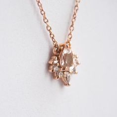 Handmade with precision and elegance, this lightweight floating pendant necklace is the perfect fine jewelry item for every day. One pear-shaped peachy-pink morganite is secured in a four-prong setting, nestled in the center. Accent stones of your selection sit atop the morganite creating a scintillating crown cluster. A slim cable link chain is attached to this pretty pendant with two small rings on each side.✦ CENTER STONE: Natural Peach Pink Morganite Shape：Pear Size： 6 x 4 mm Carat Weight：0. Crown Pendant Necklace, Crown Pendant, Crown Necklace, Morganite Diamond, Pretty Pendant, Pink Morganite, Small Rings, Peachy Pink, Peach Pink