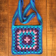 a crocheted bag sitting on top of a wooden floor