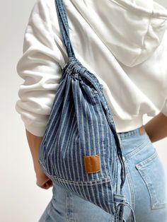 ❇️A lightweight mini blue stripe backpack purse could be the best every day carry bag. This cute boho backpack is sewn with special white-lilac thread. The frayed denim drawstring bag has a dark lilac inside pocket to keep your small personal items. On the back side of this stylish bag strap, there is a short handle, making it convenient to carry in the hands when necessary. Drawstrings of the backpack are adjustable.  ❇️This canvas backpack is comfortable and  soft to touch to the body. Althoug Small Denim Bag, Summer Cotton Backpack, Casual Cotton Backpack Styled As Shoulder Bag, Trendy Cotton Backpack For Everyday, Summer Cotton Backpack For Daily Use, Trendy Cotton Everyday Backpack, Trendy Cotton Backpack With Adjustable Strap, Trendy Cotton Backpack For Everyday Use, Trendy Cotton Backpack