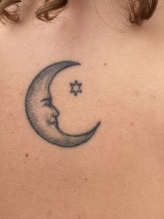 a woman with a crescent and star tattoo on her back