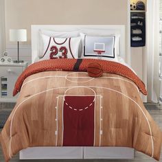 a bed room with a basketball court comforter and pillows