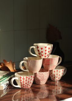 a stack of coffee cups sitting on top of a table