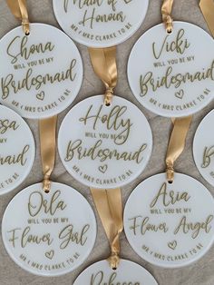 white and gold bridesmaid ornament with names on each one for the bride