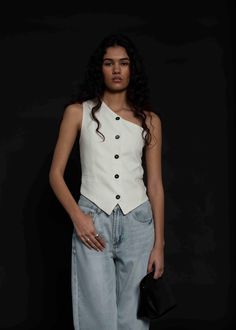 This Miss Eva classic tailored waistcoat is designed with an asymmetric neckline. Create a modern two-piece suit by styling it with a wide-leg jeans or linen trousers. Regular fit Button closure Shell: 55% Linen, 45% Viscose, Lining: 100% Viscose / Dry clean Elegant Fitted Vest With Asymmetrical Design, Elegant Fitted Asymmetrical Vest, Asymmetrical Summer Tops With Button Closure, Summer Asymmetrical Tops With Button Closure, Modern Fitted Summer Vest, Fitted Asymmetrical Summer Vest, Tailored White Summer Tops, Chic Asymmetrical Spring Vest, Chic Asymmetrical Vest For Spring