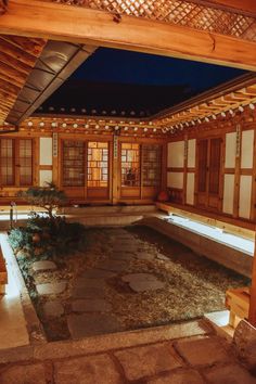 the inside of a japanese style house with stone flooring and wood trimmings