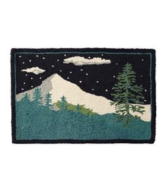 a door mat with trees and mountains in the night sky, on a white background