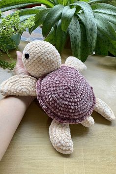 a small stuffed turtle sitting on top of a table