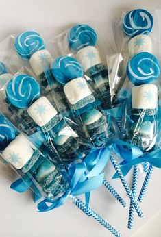 some lollipops are wrapped in cellophane and tied with blue ribbon