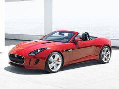 a red sports car parked in front of a building