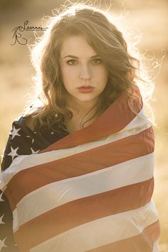 a beautiful young woman wrapped in an american flag