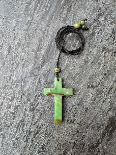 The Green Jade Cross Pendant, made from 100% natural Indonesian Jade, is a stunning piece of jewelry that exudes elegance and spiritual significance. Crafted from carefully choosen green jade, this pendant boasts a mesmerizing hue that captures the eye and captivates the soul. The cross design is a timeless symbol of faith and devotion. The verdant green color of the jade is not only visually striking but also carries symbolic meaning. Green is often associated with growth, renewal, and harmony, making this pendant not only a beautiful accessory but also a source of positive energy and tranquility. Whether worn as a personal talisman or as a cherished gift for a loved one, it serves as a constant reminder of strength, hope, and the enduring beauty of faith. Green Agate Hand-wrapped Necklaces, Green Agate Hand Wrapped Necklaces, Green Hand Wrapped Agate Necklaces, Earthy Green Agate Jewelry, Spiritual Green Moss Agate Jewelry, Handmade Green Prehnite Jewelry, Earthy Green Moss Agate Jewelry, Handmade Green Cross Jewelry, Untreated Green Bohemian Necklace