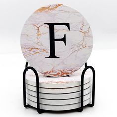 marble coasters stacked on each other with the letter f in black and white letters