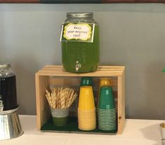 there is a mason jar with some straws in it on top of a shelf