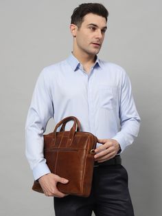 Expertly crafted from soft brown leather, this slim briefcase exudes a luxurious premium feel. The smooth finishing and brass hardware add to its elegant design. It's the perfect accessory for the modern professional, providing style and functionality in one compact package. Salient Features Material: high-quality buffalo full-grain soft leather. Storage: Roomy enough for holding a 13.3" and 15" laptop, iPad, A4 folders, a wallet, or other things Top Handle: The handles are very sturdy and durab Brown Smooth Grain Briefcase For Work, Classic Business Laptop Bag, Classic Brown Laptop Bag For Work, Classic Formal Briefcase With Laptop Sleeve, Classic Rectangular Laptop Bag For Work, Classic Office Laptop Bag With Leather Lining, Classic Bag With Laptop Sleeve, Brown Smooth Grain Business Laptop Bag, Classic Work Laptop Bag