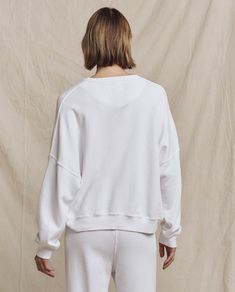 A relaxed fit with a dropped shoulder, cropped body length and clean cuffs with no distressing make this piece feel like the perfect deadstock sweatshirt flea market find. Authentic vintage details like a half moon in the back neck add extra character. Handcrafted locally in Los Angeles, our process ensures beauty and uniqueness—no two pieces are alike. 100% Cotton Machine Wash Cold, Tumble Dry Low Made in the U.S.A Relaxed Fit Crew Cropped Sweater, Relaxed Fit Cropped Sweater With Ribbed Cuffs, White Boxy Fit Cotton Sweatshirt, Oversized White French Terry Top, White Cropped Relaxed Fit Sweatshirt, Relaxed Fit Cropped Sweater With Drop Shoulder, White Cotton Cropped Sweater With Ribbed Cuffs, Relaxed Fit Ribbed Waistband Crew Neck Cropped Sweater, Casual Relaxed Fit Cropped Crew Sweater