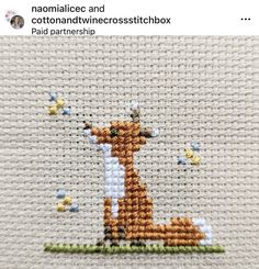 the cross stitch pattern shows a giraffe