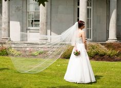 a woman in a wedding dress with her veil over her head and the words classic veil