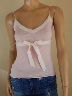 theory pink wool camisole with satin bows bust has stretch, laid flat 34 waist laid flat 28 length 21 has no flaws excellent condition Feminine Fitted Camisole With Built-in Bra, Feminine Stretch Tank Top For Daywear, Elegant Pink Tops With Built-in Bra, Fitted Cotton Camisole For Daywear, Fitted Feminine Sleeveless Camisole, Feminine Stretch Camisole For Daywear, Fitted Feminine Camisole, Feminine Fitted Tank Top With Spaghetti Straps, Fitted Feminine Tank Top With Built-in Bra