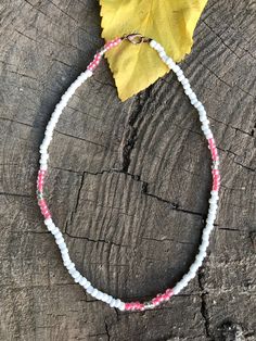 This pink and white aesthetic necklace. Seed bead choker. The beads are made of glass and they are 6mm. White Tiny Beads Choker, Handmade White Crystal Choker Necklace, Handmade Pink Choker With Round Beads, Pink Handmade Choker With Round Beads, White Beaded Choker Necklace With Colorful Beads, White Letter Beads Choker Necklace, White Single Strand Beaded Bracelet For Gift, Adjustable White Crystal Necklace With Colorful Beads, White Single Strand Choker Necklace