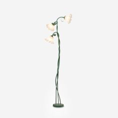 a lamp that is on top of a stand with three lights in the shape of flowers