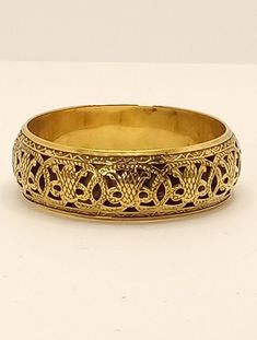 Vintage Chunky Brass Openwork Embossed Bangle Bracelet Estate Find A light weight, hollow open work brass bangle with a lot of charm. The embossed design gives this piece depth and allows the light to play on the highs and lows. Inner circumference: 8.2 inches Width: .9 inch Thickness: .2 inch This is a pre-owned vintage item, it has been cleaned, inspected and found to be in very good vintage condition with minimal signs of wear. Comes in a gift box ideal for gift giving and storage. Item# BR00 Gold Bangle With Decorative Band As Gift, Symbolic Gold Bracelets For Festivals, Formal Brass Bracelet With Intricate Design, Formal Brass Bracelets With Intricate Design, Formal Brass Bangle With Intricate Design, Ornate Bangle Bracelet With Antique Finish, Ornate Antique Gold Bangle Bracelet, Gold Bohemian Etched Cuff Bracelet, Bohemian Gold Etched Cuff Bracelet