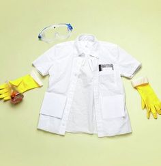 a white shirt and yellow gloves on a table