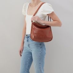 Casual meets luxe with this beautifully crafted convertible shoulder bag. Phoebe Shoulder Bag In Santa Cruz Leather  Saddle SHOULDER in Saddle Brown | Hobo® Elegant Cognac Bucket Bag For On-the-go, Classic Hobo Shoulder Bag With Detachable Handle, Classic Crossbody Hobo Bag With Detachable Handle, Luxury Baguette Bag With Leather Handles For Everyday Use, Cognac Hobo Bag With Detachable Strap For On-the-go, Elegant Crossbody Hobo Bag With Leather Lining, Leather Baguette Bag With Detachable Handle For Errands, Versatile Cognac Shoulder Bag With Leather Lining, Elegant Cognac Hobo Bag For Everyday