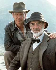 two men in suits and hats posing for the camera