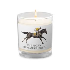 an american thoroughbred candle is shown with the horse on it's back and name