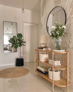 a living room filled with furniture and a plant on top of a wooden shelf next to a mirror