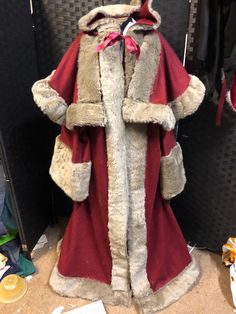 Beautiful Robe and under robe in wool type fabric edged in faux fur and embroidery Made to order so just message me your requirements red , marron or green or a combination  choice of colours and light , dark fur or cream, (fur in photo has sold out ) This was originally made for the Royal castle Xmas celebrations last year in Durham sleeves on robe 15' deep , under robe 11" deep , fur approx 4" wide , deep hood attached to theSHORT CLOAK which is separate to the robe  , a hat can be provided as Victorian Winter Coat, Medieval Santa Claus, Victorian Greatcoat, Victorian Santas Father Christmas, Edwardian Fur Coat, Red Costume, Santa Outfit, Royal Castles, Father Christmas