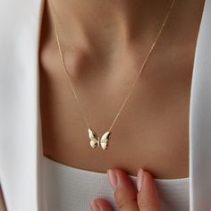 14K Solid Gold Butterfly Necklace | Minimal Dainty Necklace Delight in the elegance and simplicity of our 14K Solid Gold Butterfly Necklace. This minimal, dainty piece is designed to bring a touch of delicate beauty to your everyday look. Butterflies are rich in symbolism across various cultures and contexts. Here are some common meanings associated with butterflies: Transformation and Change: Butterflies undergo a complete metamorphosis from caterpillar to butterfly, symbolizing profound transf Elegant Everyday Necklaces Stamped 14k, Elegant Everyday 14k Stamped Necklaces, Dainty 14k Stamped Necklace, Feminine 14k Yellow Gold Jewelry, Feminine Yellow Gold Necklace For Anniversary, Lifecycle Of A Butterfly, From Caterpillar To Butterfly, Caterpillar To Butterfly, Gold Butterfly Necklace