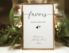 a sign that says favors on it next to some flowers and candles in the background