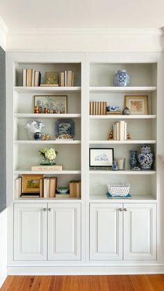 a white bookcase filled with lots of books